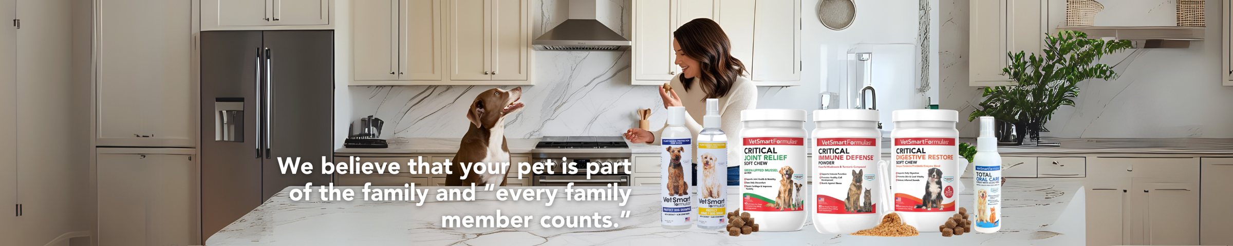 Pet parent giving VetSmart Formulas Critical line supplements to her dog in the kitchen — we believe that your pet is part of the family